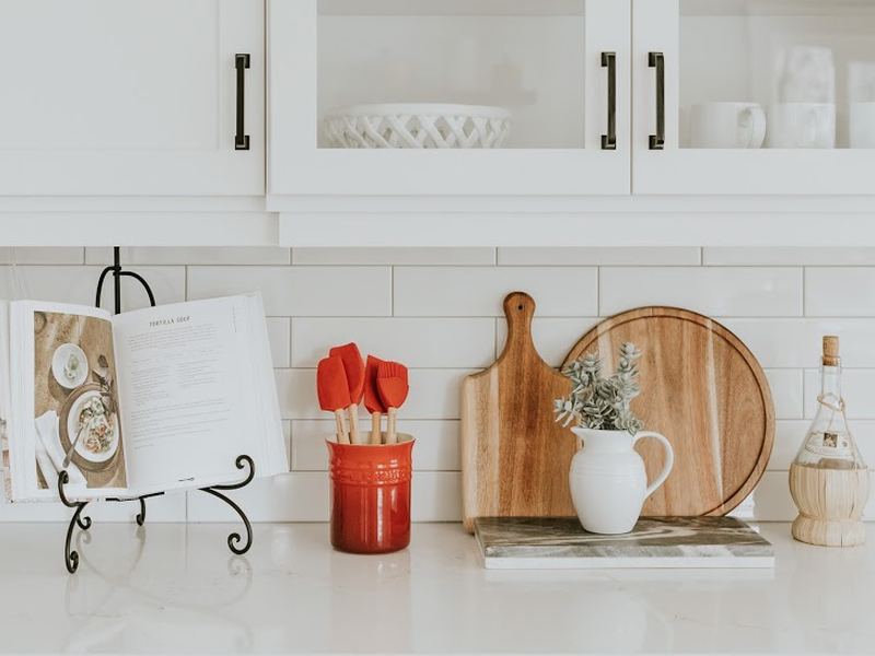 A bright kitchen counter with shaker cabinetry and a subway-tile backsplash.